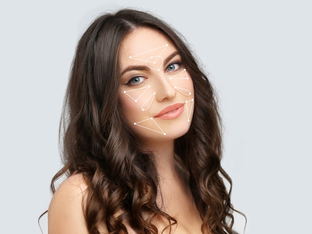 A woman with a facial mapping illustration, showing areas commonly treated with Botox or Xeomin for wrinkle reduction.