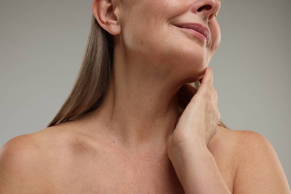 Close-up of a woman's neck and chin, highlighting mild skin laxity, ideal for non-surgical neck tightening treatments.